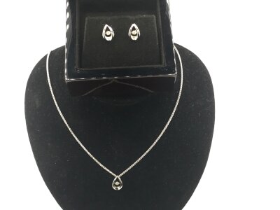 A 9ct white gold necklace set with diamond and matching earring.