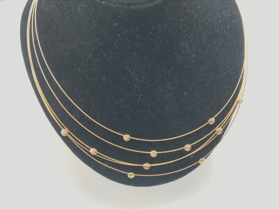 An 18ct gold multi strand necklace set with diamonds.
Approximately 9.17g