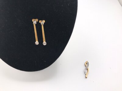 A pair of 18ct gold earrings set with diamonds 3.03g and a 9ct gold pendant set with CZ 3.27g