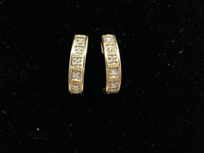 A pair of 9ct gold diamond set earrings.
2.50g