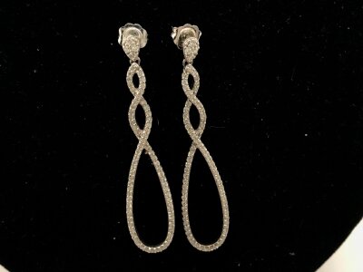 A pair of 18ct white gold drop earring set with diamond chips open loop.
5.61g