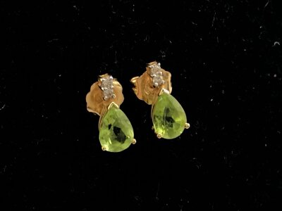 A pair of 18ct gold earring set with green tourmaline and small diamonds.
1.30g