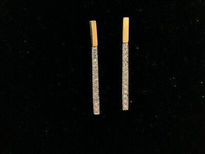 A pair of 18ct two tone gold earrings set with diamond chips.
2.11g