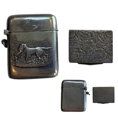 A continental silver vesta case with gun dog hunt scene, together with continental small silver floral engraved pill box.