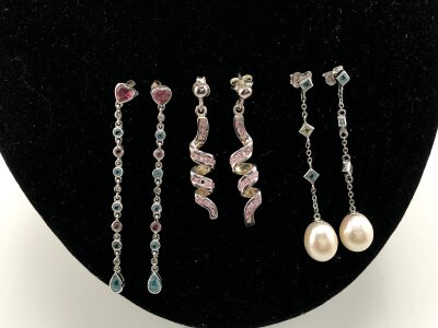 Three pairs of 9ct gold earrings set with assorted stones and pearls.
10.61g