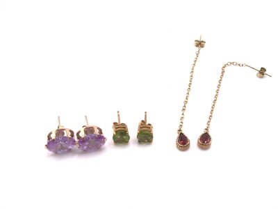 Three pairs of 9ct gold earring set with coloured stones.
4.81g