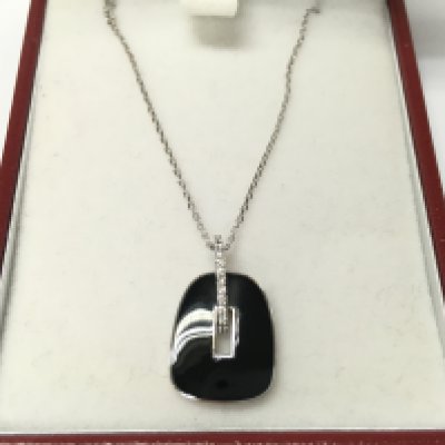 A 14ct white gold necklace with black enamel and diamonds pendant.