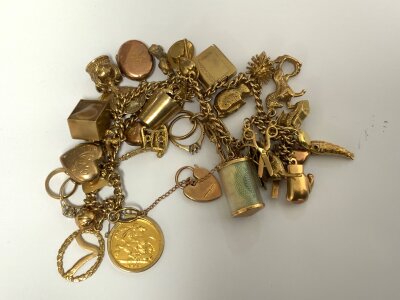 A 9ct gold charm bracelet, various 9ct charms total weight 74.1g including a 1903 half sovereign.