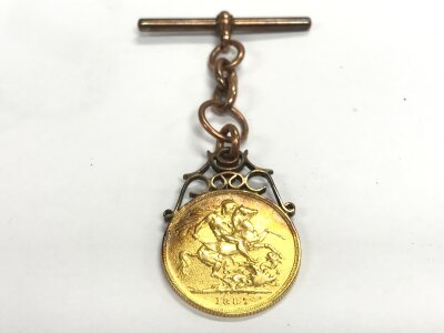 A 1887 full sovereign with a 9ct gold mount T bar. 11.28g total weight.