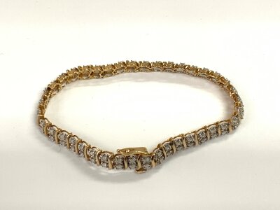 A 9ct gold line bracelet inset with white stones. 11.1g 18cm