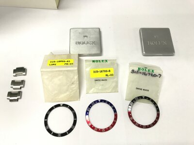 Three Rolex bezels with original packaging and three spare steel links.
Bezels for Submariner GMT Pepsi and GMT Coke.