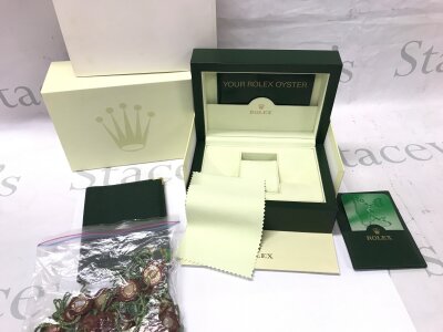 A Rolex box with some leaflets and a large collection of wax swing tags.