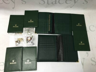 A collection of assorted Rolex items including a submariner anchor and wax seal. Also some random links which are not Rolex.
