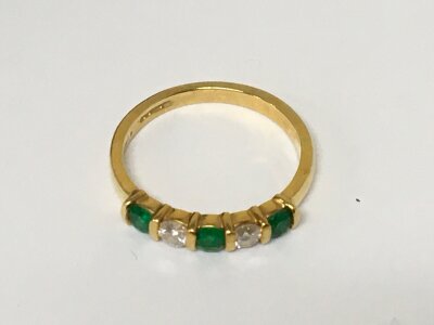 An 18carat gold ring set with alternating emerald and diamonds weight 3g ring size N.