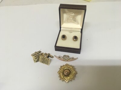 A 9carat gold brooch set with a heart and seed pearl a pair of  9carat gold garnet earrings a gold mounted mourning brooch and a pair of silver gilt cufflinks