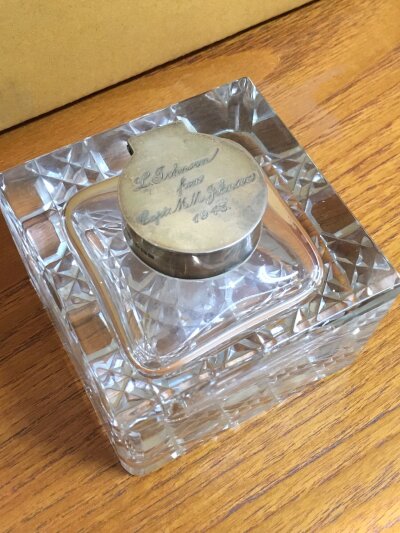 A silver hallmarked topped glass ink well. 10cm wide 10cm tall