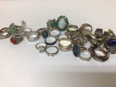 A collection of twenty five silver rings set with coloured stones CZ. Weight 185g