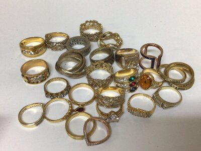 A collection of silver gilt and gold plated rings set with CZ and other coloured stones.