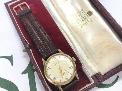 A 9 carat gold cased Garrard watch, seen working. 37g total weight