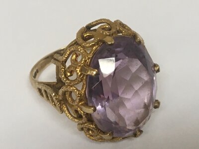 A 9carat gold ring set with a large Amethyst colour stone total weight 8.5 ring size O.