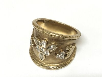 A 9carat gold ring set with a pattern of raised white stones possibly white sapphire. Weight 9g ring size Q.