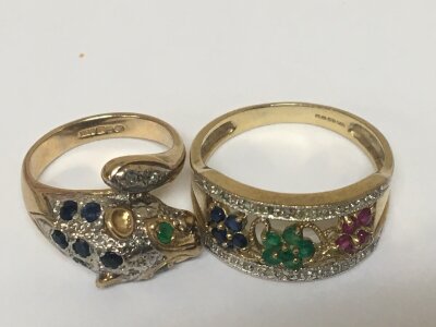 Two 9carat gold rings one in the form of a leopards head and one other floral pattern both set with sapphire ruby emerald and chip diamonds. Weight 9g