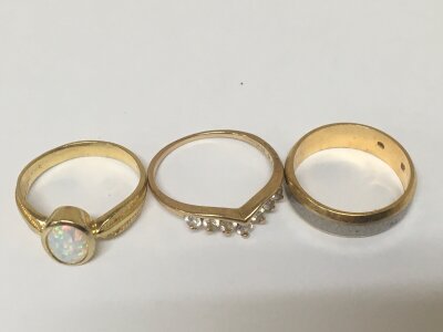 Two 14carat gold rings set with an Opal doublet CZ weight 5g and a gold wedding band possibly 750 18carat weight 5g