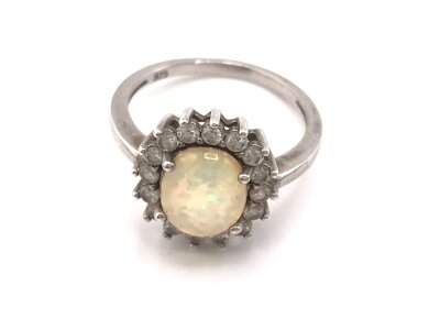 A silver ring set with Opal and CZ. 
Size P
