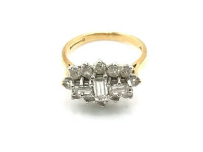 A 15ct gold ring set with a pattern of baguette and brilliant cut diamonds. Size L 1/2