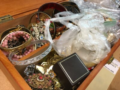 A box of costume jewellery including bangles, brooches, etc