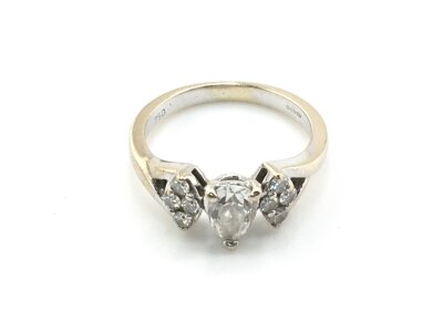 An 18ct white gold ring set with pear shaped diamonds and small brilliant cut diamonds. Size J