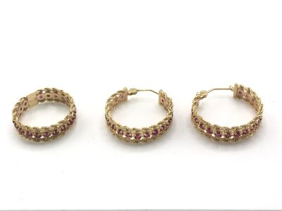 A pair of unmarked 14k gold Ruby set earrings and a matching ring size N