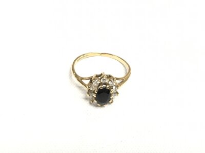 A 9ct gold ring set with a central sapphire surrounded by diamonds, approx 1.5g and approx size I-J.