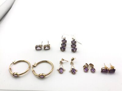 Four pairs of 9ct gold and amethyst earrings 4.88g  and two pairs of silver examples.