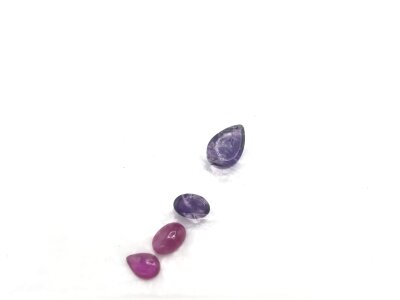A parcel of loose gemstones including amethyst and Ruby. Approximately 2.32ct amethyst and 1.16ct rubies,
