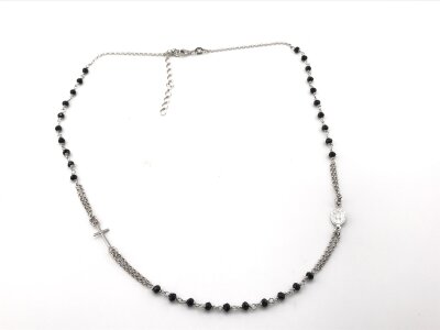 A silver necklace with black faceted glass beads.