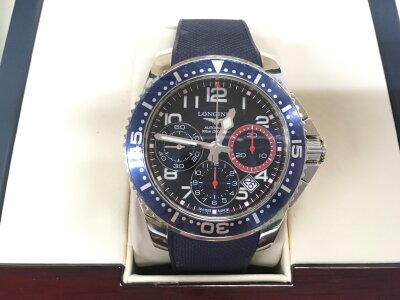 A boxed Longines automatic chronograph watch with paperwork and original metal strap.