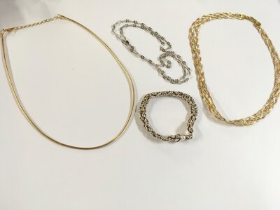 A tri tone silver necklace , silver bracelet and two other silver necklaces. Total weight approximately 50g