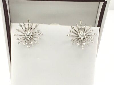 A pair of 9ct white gold earrings of floral open modern design pattern set with white stones.
Approximately 23mm diameter