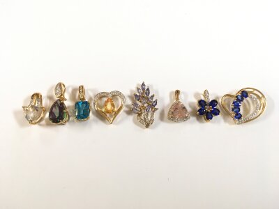 A collection of 9ct gold pendants set with various gem stones. 13g total weight