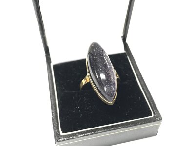A 9ct gold ring set with polish Cabochon stone.