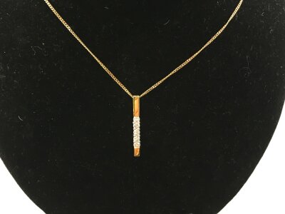 An 18ct gold diamond set pendant. 
2.61g and pendant approximately 24mm
