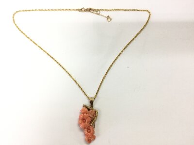 A 9ct gold necklace with coral pendant.
12.23g