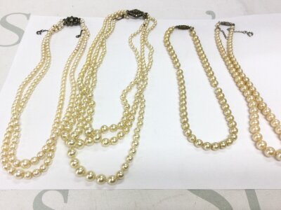 A collection of simulated pearl necklaces.