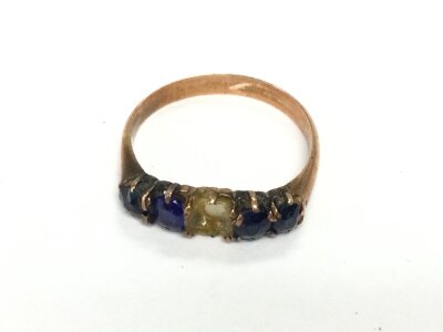 A 9ct rose gold ring (unmarked) set with blue stones. Size K and 2.27g