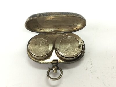 A silver full and half sovereign case.