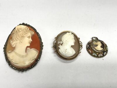 Two cameo brooches and a vintage enamel cameo pendant.