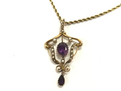 A 9ct gold Edwardian pendant with amethyst and seed pearls on a 9ct gold chain.