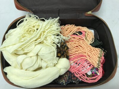 A box of handmade beaded necklaces