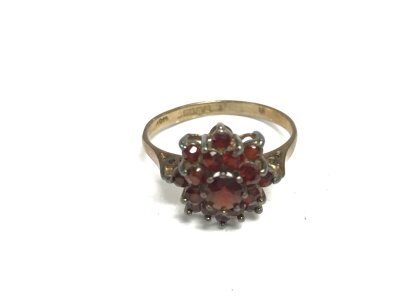 A 9ct gold cluster ring set with garnets. Size L and 2.34g